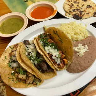 Chicken, steak and al pastor tacos and cheese pupusa