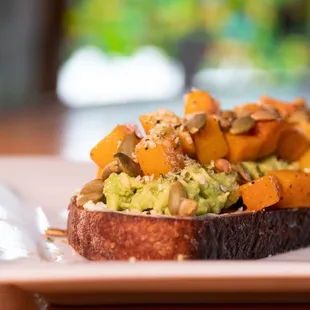 Avocado Toast! With roasted butternut squash, smashed avocado, house made almond ricotta, and toasted pepitas on a thick slice of sourdough.