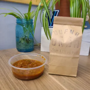 a bowl of salsa and a bag of bread