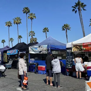 people shopping at a farmers market