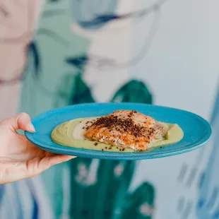 a person holding a plate of food