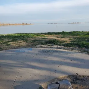 Here's the cement pad where your table and fire pit is located. The site is close to the water.