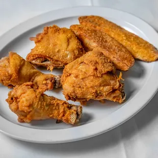 a plate of fried chicken wings