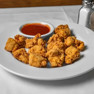 a plate of deep fried chicken nuggies