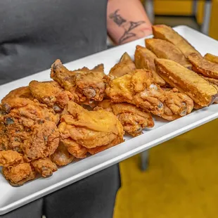 a plate of fried chicken and french fries