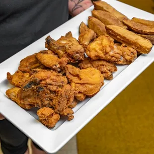 a plate of fried chicken and french fries