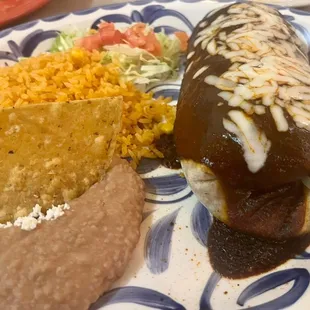 Burrito De Mole with some delicious refried beans and rice