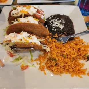 Beef, hard taco platter with rice and black beans.