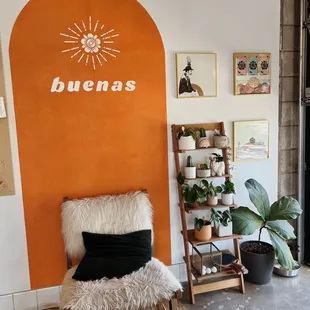 a chair in front of an orange wall