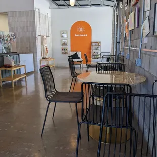 a dining area with tables and chairs