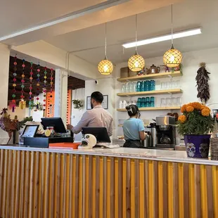 Front counter, cute coffee cups.