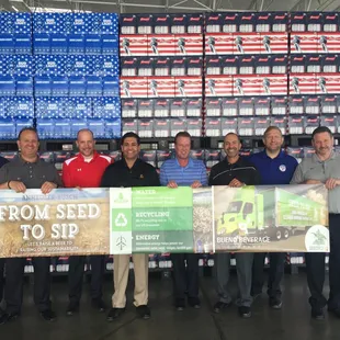 a group of men holding a banner