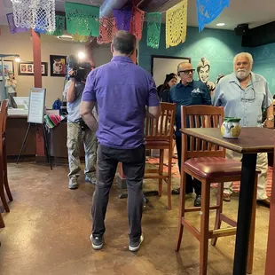 Fox News reporter covering the opening of Bueno Cafe