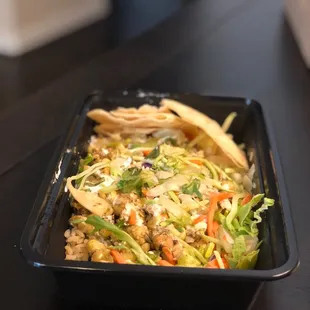 Poblano Chicken Bowl-chicken, corn,with Poblano pepper sauce, rice, salad, onions, cilantro, fresh Cotija and creama