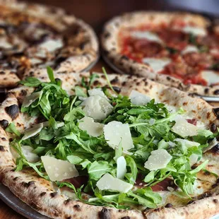 three pizzas on a table