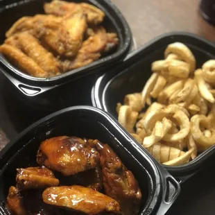 three containers of chicken wings and macaroni and cheese