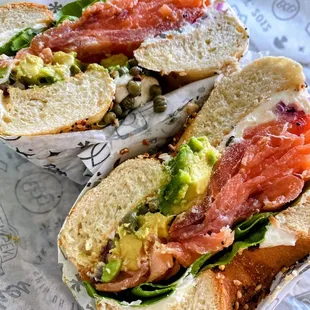 Everything bagel with lox, spinach, avocado, plain cream cheese, capers, tomato, and red onion