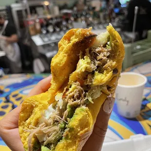 a hand holding a sandwich