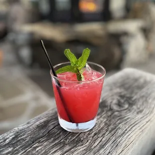 a drink in a glass on a wooden table