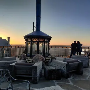 a group of people standing around a fire pit