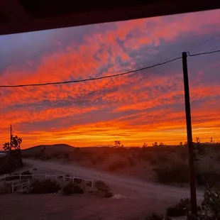a sunset over a dirt road