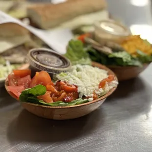 a bowl of salad and a sandwich