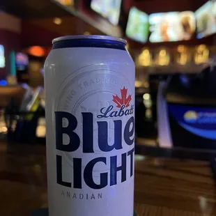 a can of blue light on a table