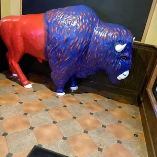 a red and blue buffalo statue