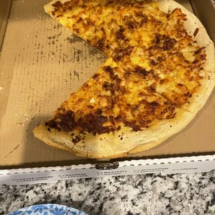 a half eaten pizza in a box