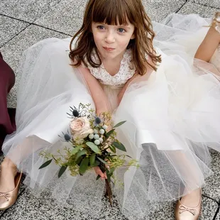 a little girl in a wedding dress