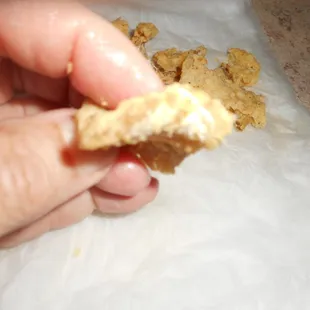 a hand holding a piece of food