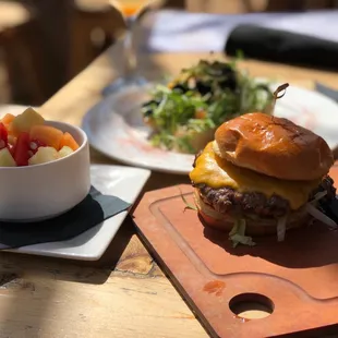 a burger and a bowl of fruit