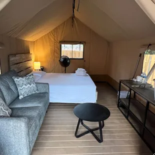 New in 2024! Glamp Garden - an adults only outdoor getaway that includes a Queen bed, electricity, seating, &amp; shared bathrooms/showers.