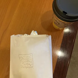 a paper bag and a coffee cup