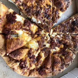 Half chorizo half bacon breakfast pizza. Looks good but was severely under cooked underneath!