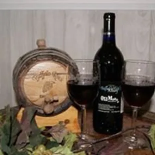 a barrel of wine and two glasses of wine