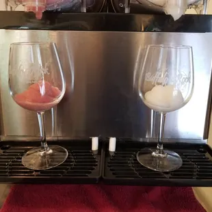 two glasses of wine being poured