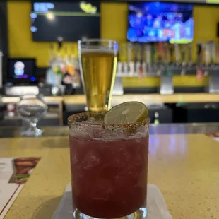 a bloody drink with a lime slice on the rim