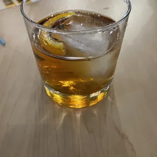 a glass of whiskey on a table