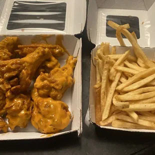 two takeout boxes with fries