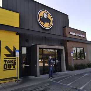 a man standing outside of a restaurant