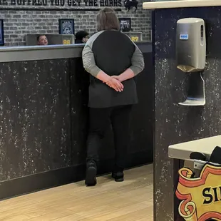a woman standing in front of a counter