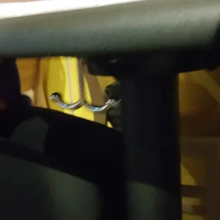 They kept the ladies in mind.....purse hooks under the tables