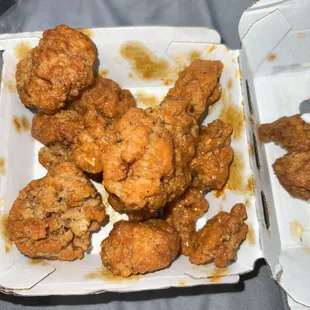 two takeout boxes of buffalo wings