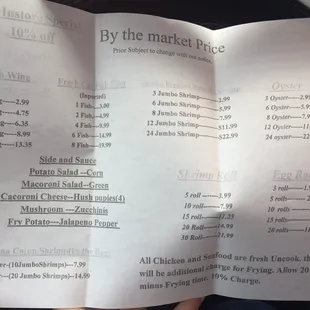 a hand holding a menu