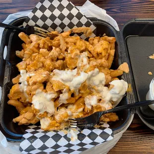 a tray of fries and a fork