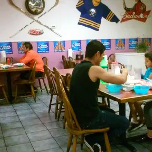 a group of people eating in a restaurant
