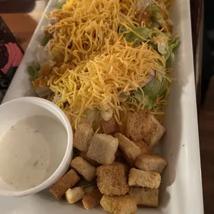 a plate of food with cheese and croutons