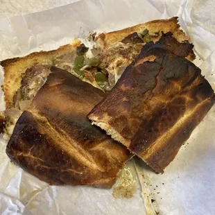 a burnt piece of pizza