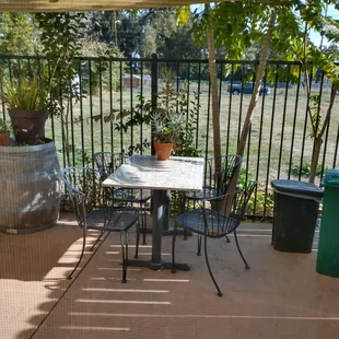 a patio with a table and chairs